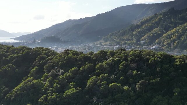 New Zealand Picton aerial view shows a beautiful urban waterfront landscape along Queen Charlotte Sound with scenic Marlborough mountains and port scenery for travel tourism