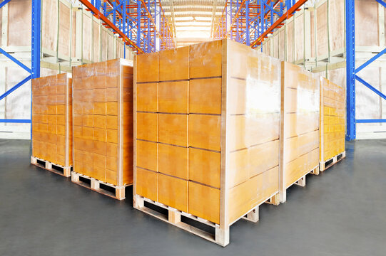 Bulk of Package Boxes on Pallets. Tall Shelves Storage Warehouse. Cardboard Boxes. Supply Chain, Goods Shipment. Warehouse Shipping Logistics.	
