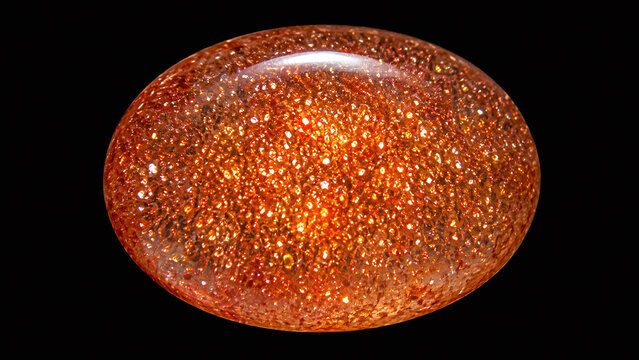 Polished sunstone feldspar cabochon macro showing vivid golden-copper aventurescence sparkle metallic platelet inclusions warm orange body on black background