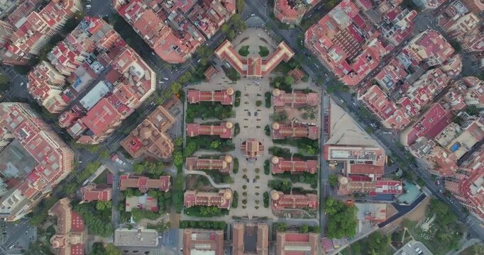 Cinematic aerial of Barcelona city skyline. Drone fly over Eixample residential famous urban grid and Hospital of Sant Pau with morning sunrise cityscape. Catalonia, Spain. Travel Destination.