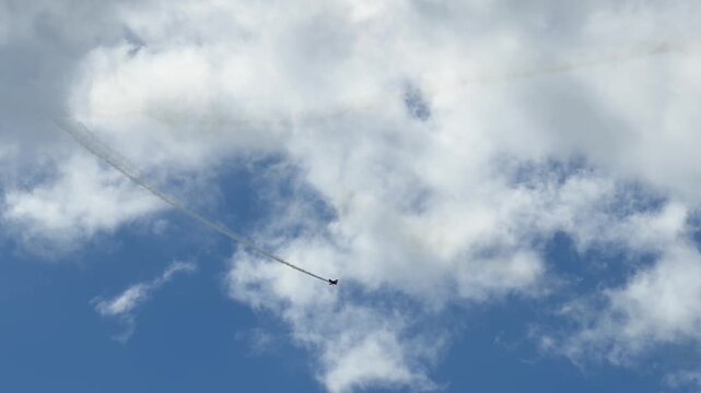Stunt Plane Performing Aerobatics with Smoke Trails Over Gold Coast