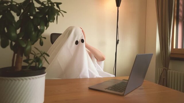 Funny ghost working from home and being mad at an open laptop and gesturing in confusion during a stressful office conversation