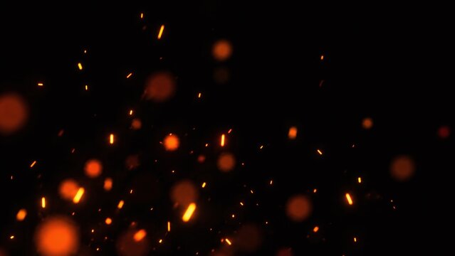 Fire sparks background photo with glowing embers floating in dark night