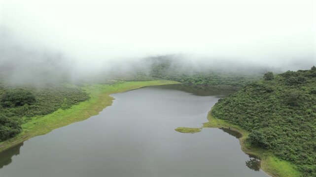 4K drone aerial view of Yala Provincial Park in Jujuy, Argentina. Misty mountain lakes surrounded by lush Yungas forests and dense green vegetation in a spectacular Andean landscape.