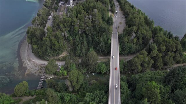 4K drone aerial view of the bridge between Lake Correntoso and Lake Nahuel Huapi in Neuqu&eacute;n, Argentina. The scenic road connects two Patagonian lakes surrounded by forests and mountains.