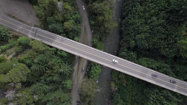 4K top-down drone view of the bridge connecting Lake Correntoso and Lake Nahuel Huapi in Neuqu&eacute;n, Argentina. The road crosses the landscape between two iconic Patagonian lakes.