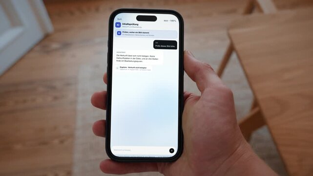 A verification screen checks whether an image carries traceable content credentials. Point of view shot with the phone held in the hand. Useful for knowing what to trust online.