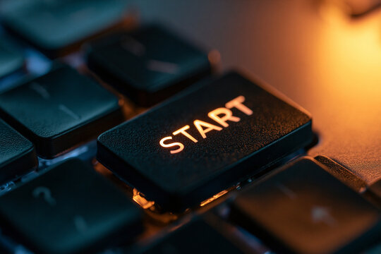 Illuminated START button on a dark keyboard, symbolizing new beginnings.