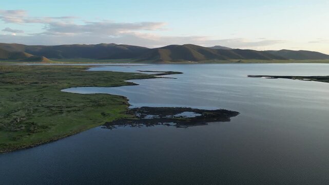 Flyover Terkhiin Tsagaan Lake in steppe terrain in remote Mongolia
