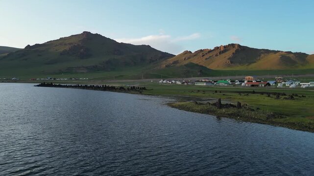 Flyover lake shore Terkh Enkh resort on green Mongolian steppe