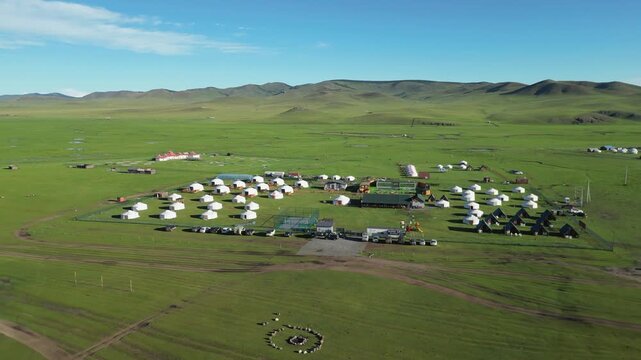 Aerial pulls out from Jaran Tsagaan Hot springs Resort, Mongolian steppe