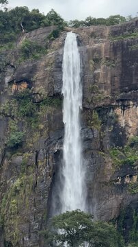 Scenic view of majestic Diyaluma waterfall cascading down rocks in Sri Lanka.