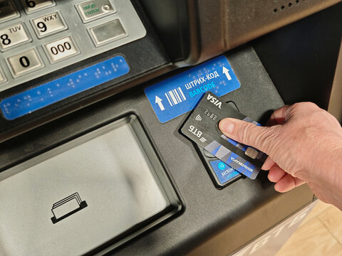 Kirov, Russia - July 08, 2026: Using a card at a modern ATM for cash withdrawal and banking services