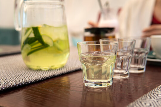 3 glasses of cool refreshing lemonade are on a wooden table in a summer cafe. Homemade lemonade