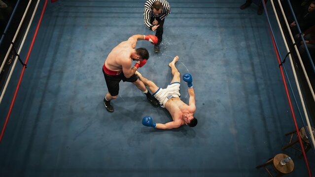 Intense Boxing Match in Ring with Two Fighters and Referee Mid-Action
