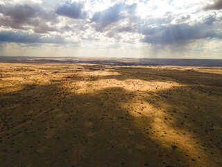 Cloud shadows drifting over a vast dry plain © Luigi