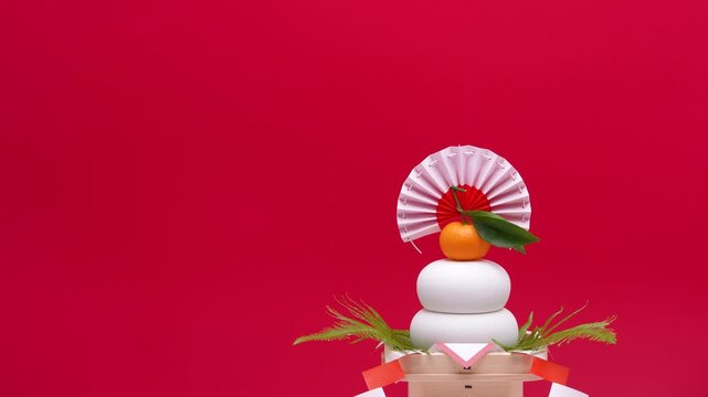 鏡餅を右側に配置し、赤白背景でティルトダウン撮影した動画　低い三宝	