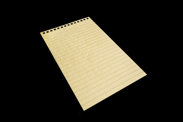Notebook paper page isolated on black JPEG background, lying on a shelf. © vovan