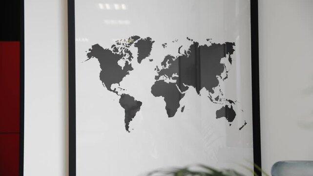 A world map of planet Earth hangs in a frame on the wall.