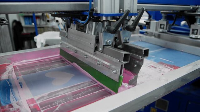 A textile printer makes prints on T-shirts.