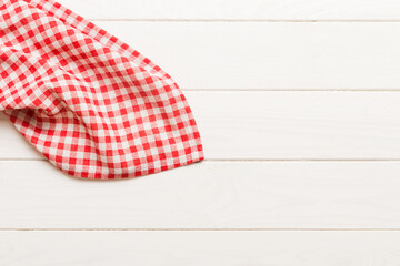 Obraz premium top view with red empty kitchen napkin isolated on table background. Folded cloth for mockup with copy space, Flat lay. Minimal style