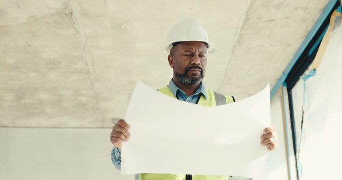 Black man, engineer and reading at site with document, blueprint and layout for construction. Mature person, contractor and walk at worksite with paperwork, floor plan and information on architecture