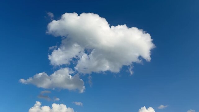 Bright white clouds in a clear blue sky.