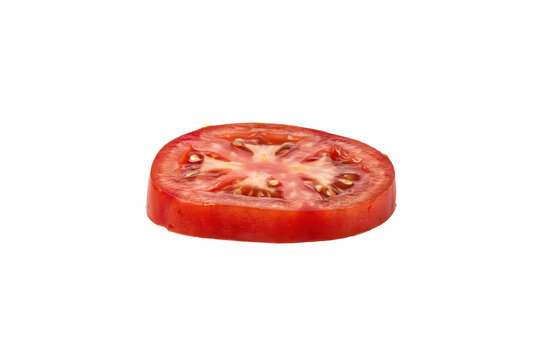 A single fresh red tomato slice showing internal seeds and pulp texture isolated on a transparent background
