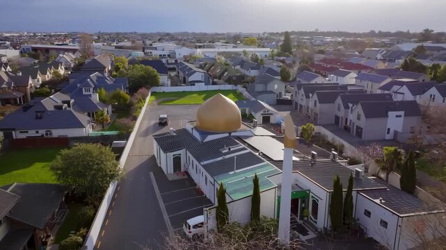 Aerial View of Mosque with Golden Dome and Minaret in Urban Residential Neighborhood