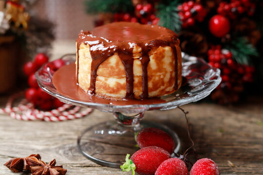 Portion of traditional Christmas cheesecake covered with chocolate.