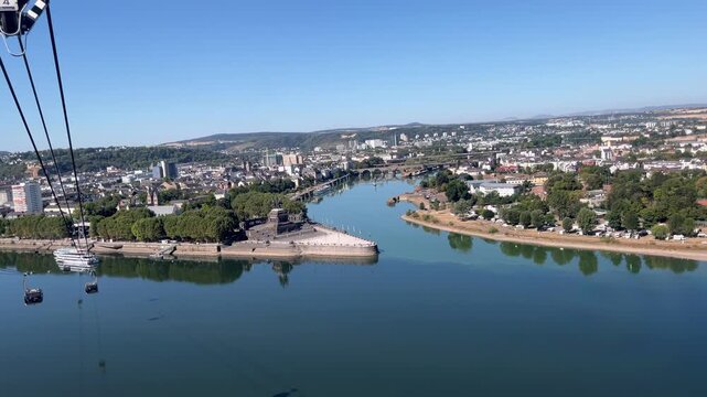 selective focus gondola cable car approaching Deutsches Eck above Koblenz riverscape