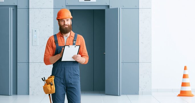 Construction worker with clipboard and helmet