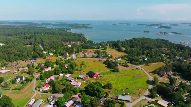 Aerial view backwards over the Rosala village, sunny, summer day in Finland