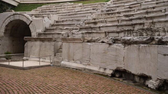 Pan and zoom in shot showing detailed stone seating rows and narrow stairs of the Ancient Roman Stadium of Philippopolis in Plovdiv.