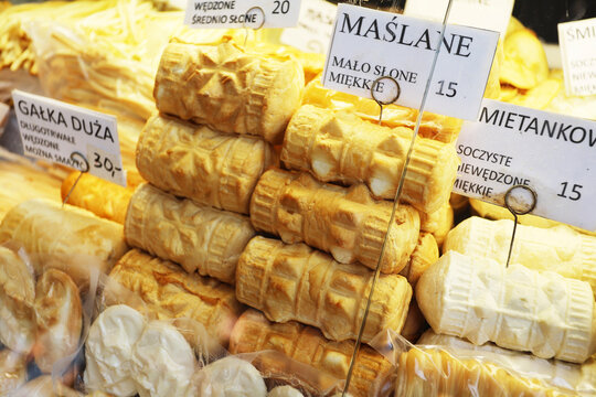 ZAKOPANE, POLAND - AUGUST 28, 2026: Refrigerated display counter filled with various traditional oscypek cheeses and Podhale regional dairy products in Zakopane.
