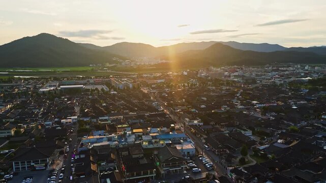 Aerial view tilting over the cityscape of Gyeongju, golden hour in South Korea