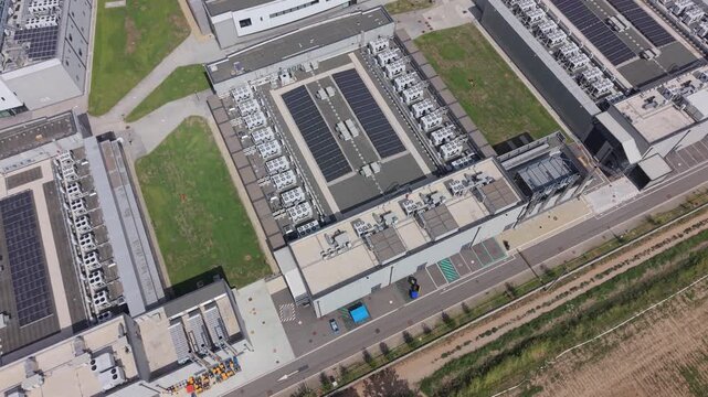 Aerial view large data center campus with multiple facilities, technical systems, cooling equipment, utility areas and internal roads
