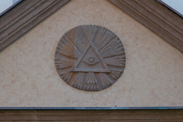 eye of providence carved relief triangular pediment stone church facade beige wall architectural detail slovakia religious symbol concept of religion, history, architecture © Lana Pietukhova