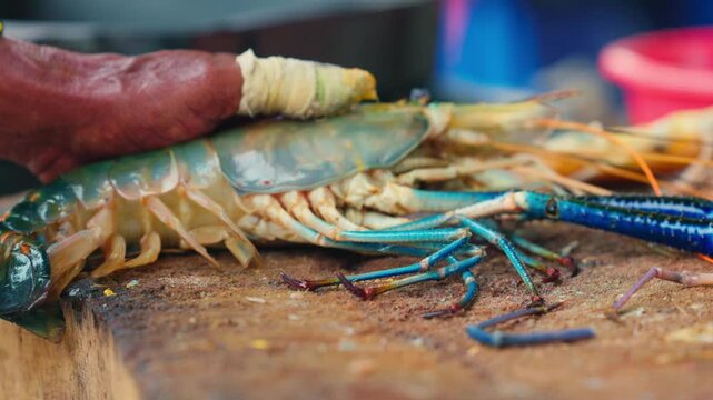 Cutting process of giant freshwater Rosenberg shrimp lat. Macrobrachium rosenbergii at fish market, seafood cutting process slow motion.