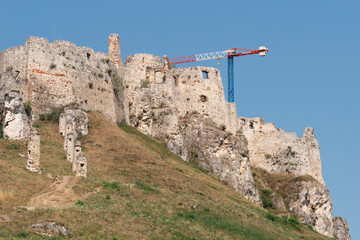 spis castle ruins stone wall battlements medieval fortress slovakia clear blue sky grassy hillside historic landmark concept of travel, history, tourism © Lana Pietukhova