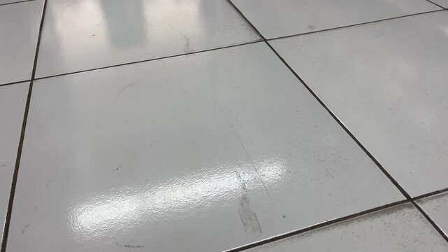 Perspective view of white ceramic floor tiles texture background