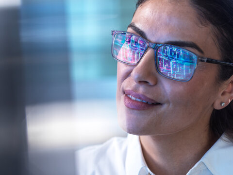 Smiling AI engineer designs future electronic products at the office