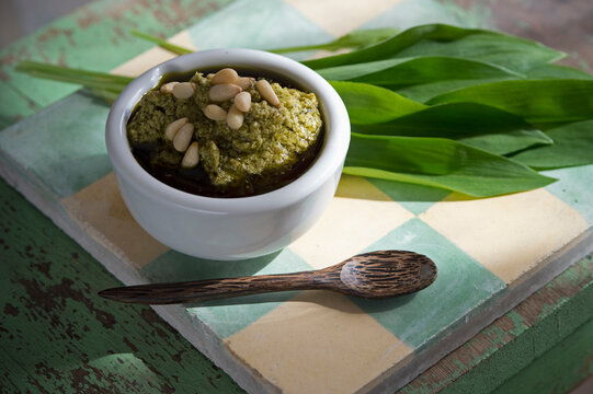 Bowl of ramson pesto garnished with pine nuts and ramson leaves, Allium Ursinum