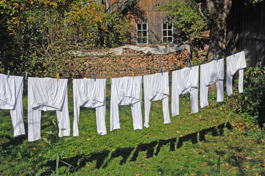 Gemany, Buchendorf, Washing line with pyjamas in backyard