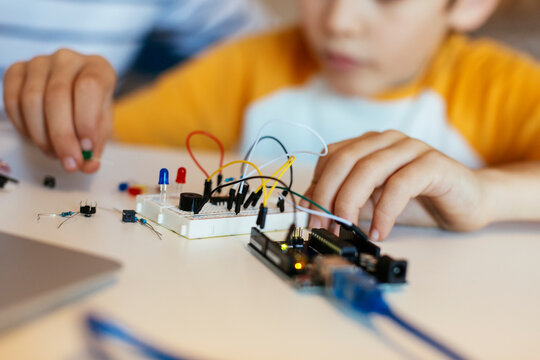 Father and son assembling an electronic construction kit
