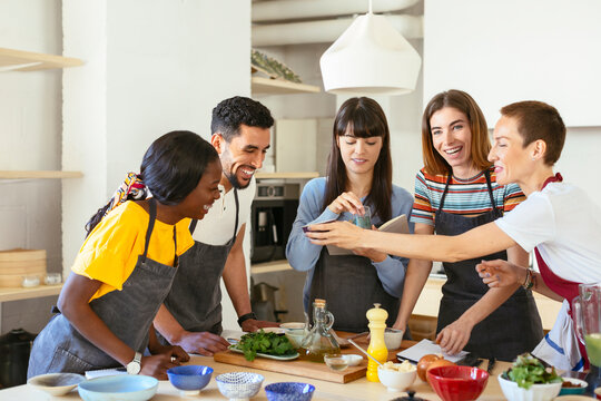 Happy friends and instructor in a cooking workshop