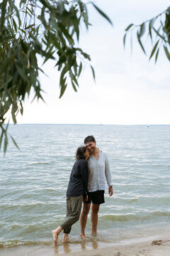 Happy couple embracing in the sea at the beach during summer weekend
