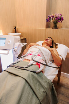 Woman receives lipolaser treatment at a modern beauty clinic