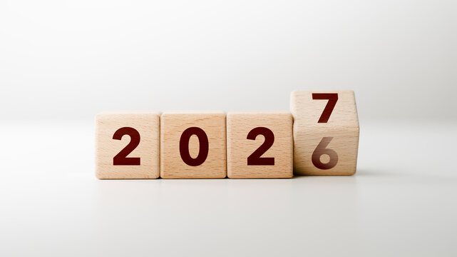 2027 Happy new year concept. Wooden cube block change from 2026 to 2027 on white background for fresh beginnings, annual change, future planning, countdown. Business resolutions goals