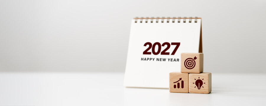Business goal setting in 2027, future planning, new year resolutions, strategy. 2027 New Year calendar with wooden blocks target, growth, and ideas icons. business success concept.